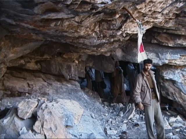 Devotees coming out of the cave shrine complex